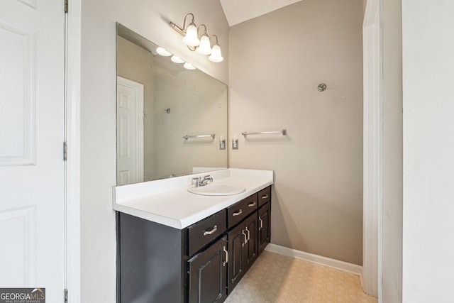 bathroom with tile patterned floors, baseboards, and vanity