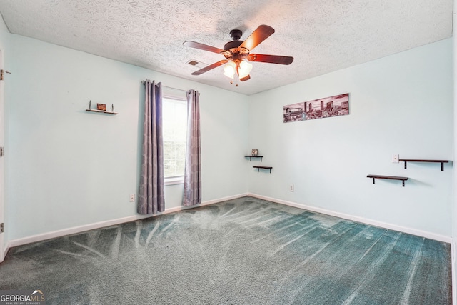 unfurnished room featuring a textured ceiling, ceiling fan, baseboards, and carpet