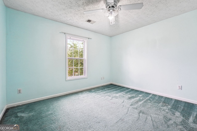 carpeted empty room with visible vents, a textured ceiling, baseboards, and ceiling fan