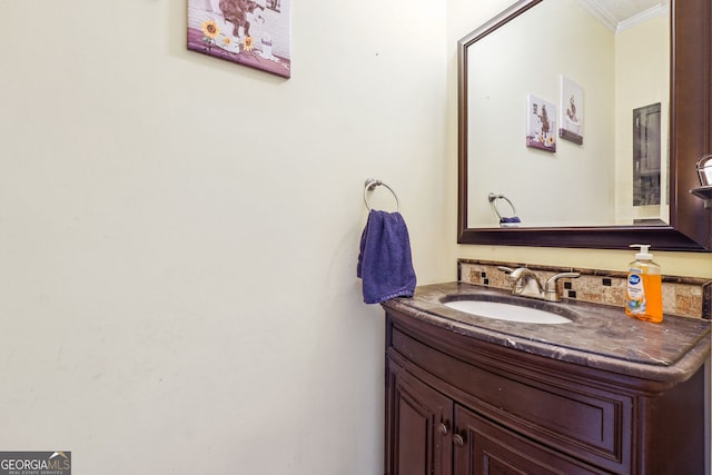 bathroom with crown molding and vanity