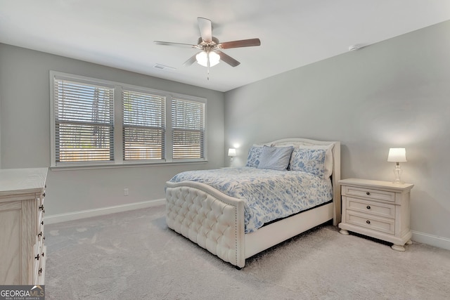 bedroom featuring visible vents, ceiling fan, light colored carpet, and baseboards