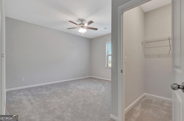 interior space with ceiling fan, carpet floors, and baseboards