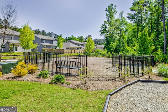 exterior space with a residential view, a lawn, and fence
