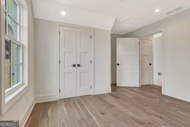 124 Morgan St, Senoia, GA 30276 - unfurnished bedroom with baseboards, light wood-style floors, a closet, attic access, and recessed lighting