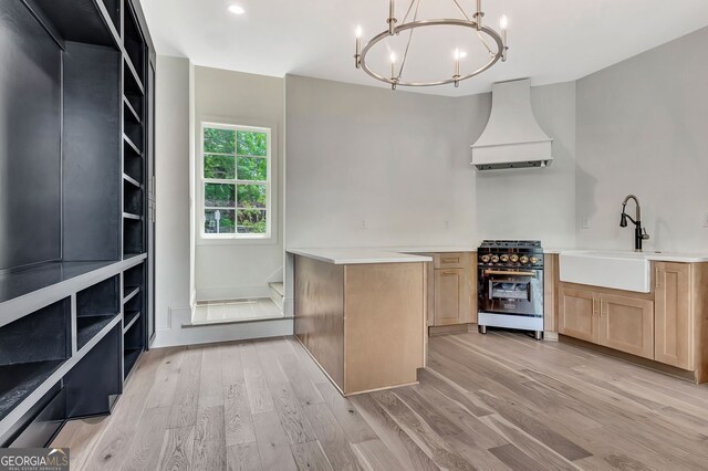 124 Morgan St, Senoia, GA 30276 - kitchen featuring high end range, custom range hood, a sink, a chandelier, and light wood-style flooring