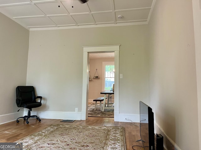 interior space featuring ornamental molding, visible vents, wood finished floors, and baseboards