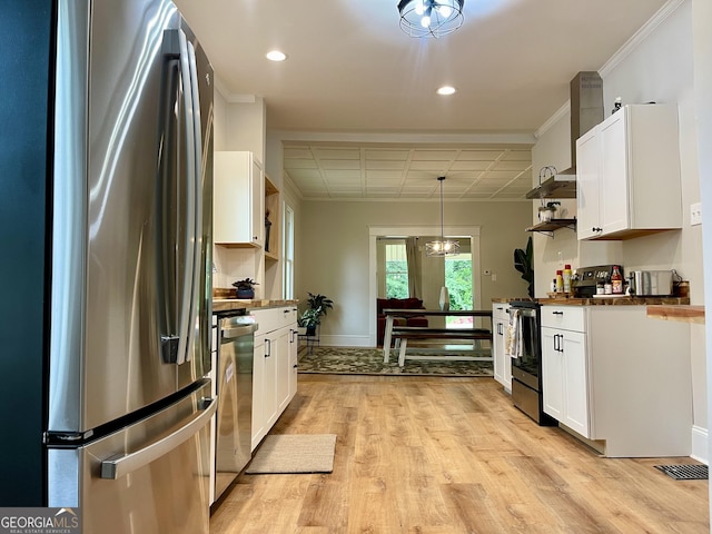 kitchen featuring recessed lighting, white cabinets, stainless steel appliances, and light wood-style floors