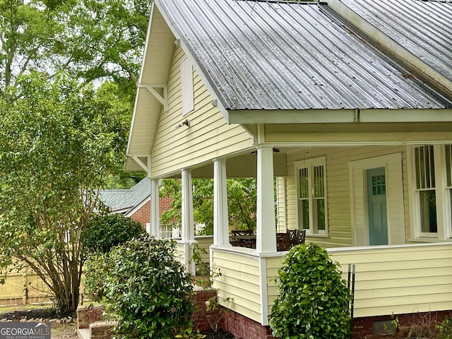 view of home's exterior with a porch and metal roof