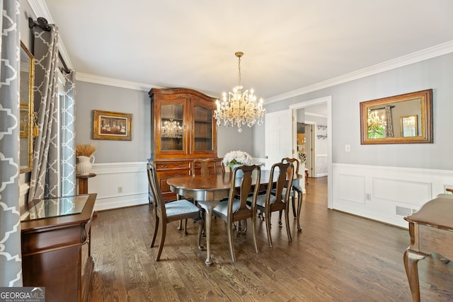 120 N Blf, Alpharetta, GA 30004 - dining space featuring a chandelier, ornamental molding, dark wood-style flooring, wainscoting, and a decorative wall