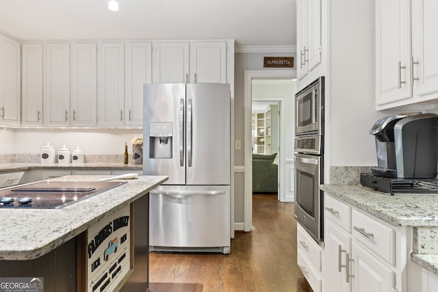 120 N Blf, Alpharetta, GA 30004 - kitchen featuring appliances with stainless steel finishes, white cabinetry, wood finished floors, crown molding, and light stone countertops