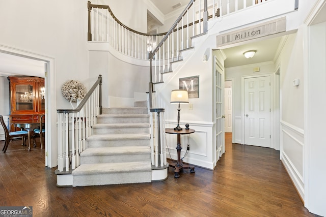 120 N Blf, Alpharetta, GA 30004 - stairway with ornamental molding, wood finished floors, a decorative wall, and a towering ceiling