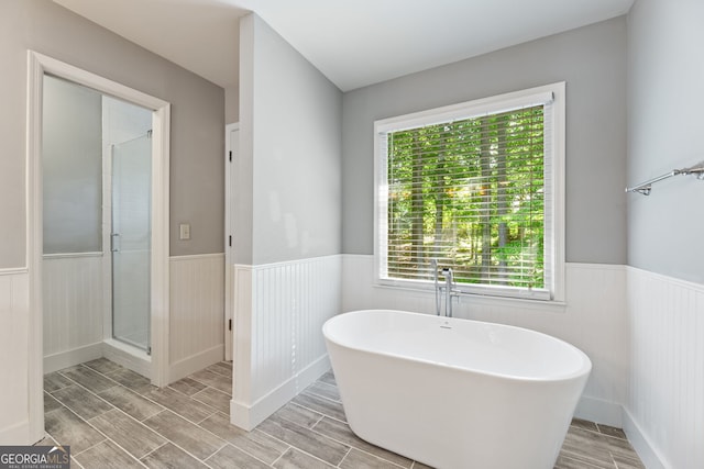 120 N Blf, Alpharetta, GA 30004 - bathroom featuring wainscoting, wood tiled floors, a freestanding tub, and a shower stall