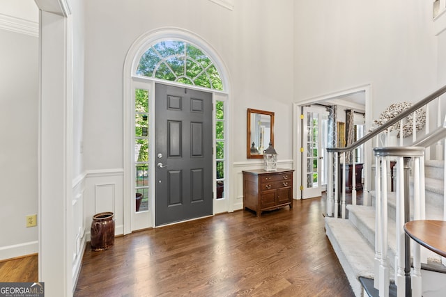 120 N Blf, Alpharetta, GA 30004 - foyer entrance with stairway, a decorative wall, dark wood finished floors, a high ceiling, and a wainscoted wall