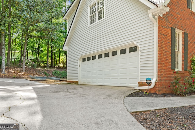 120 N Blf, Alpharetta, GA 30004 - view of side of home featuring driveway, brick siding, and an attached garage