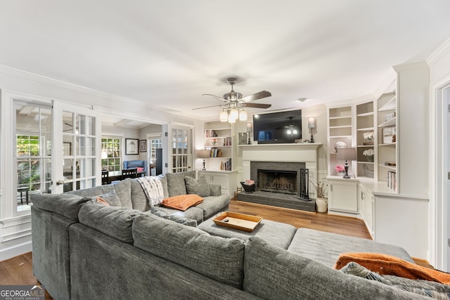 120 N Blf, Alpharetta, GA 30004 - living room with light wood-style floors, crown molding, ceiling fan, a brick fireplace, and built in features