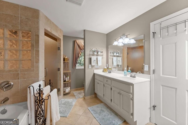 bathroom with tile patterned floors, a shower with door, double vanity, a sink, and visible vents