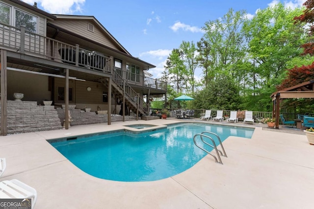 view of pool with stairway, a patio area, a fenced in pool, an in ground hot tub, and a deck