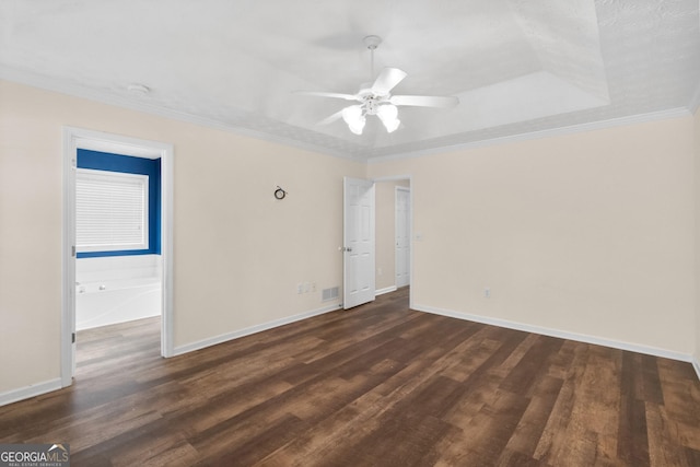 unfurnished room featuring dark wood-type flooring, ceiling fan, baseboards, visible vents, and crown molding