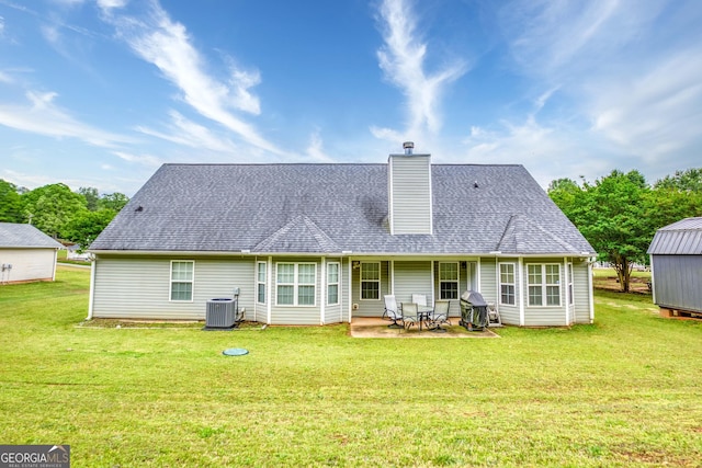407 Gladiola Dr, Auburn, GA 30011 - rear view of house with a chimney, a patio, roof with shingles, cooling unit, and a lawn