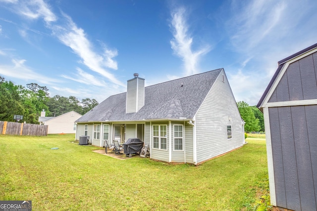 407 Gladiola Dr, Auburn, GA 30011 - back of property with a patio, a yard, a chimney, and fence