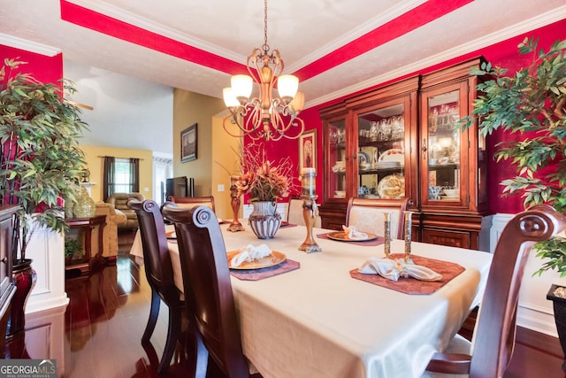 407 Gladiola Dr, Auburn, GA 30011 - dining area featuring wood finished floors, crown molding, a notable chandelier, and a tray ceiling