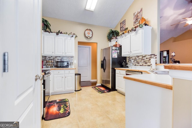 407 Gladiola Dr, Auburn, GA 30011 - kitchen with backsplash, white cabinets, and appliances with stainless steel finishes