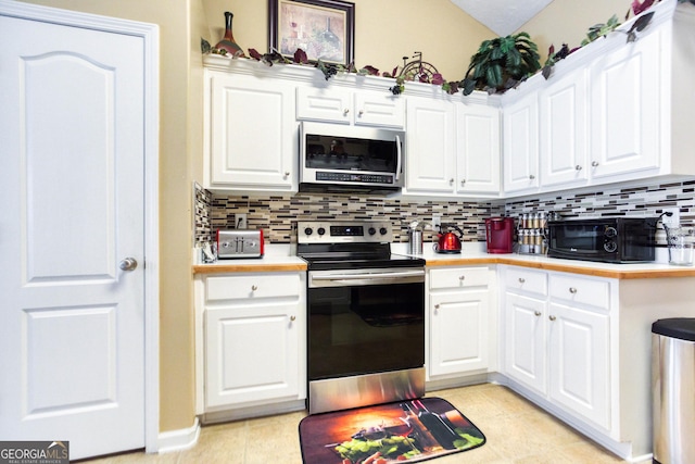 407 Gladiola Dr, Auburn, GA 30011 - kitchen with stainless steel appliances, light tile patterned floors, light countertops, white cabinets, and backsplash