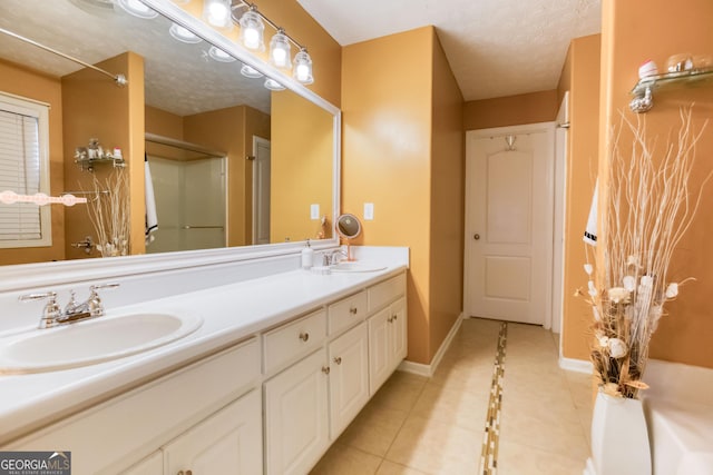 407 Gladiola Dr, Auburn, GA 30011 - full bathroom featuring baseboards, a shower with door, tile patterned flooring, and a sink