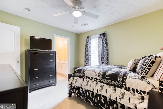 407 Gladiola Dr, Auburn, GA 30011 - carpeted bedroom featuring ceiling fan, visible vents, and ensuite bathroom