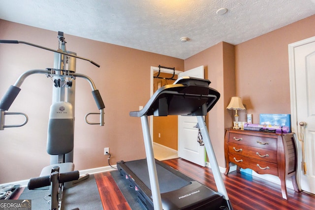 407 Gladiola Dr, Auburn, GA 30011 - exercise room with a textured ceiling, wood finished floors, and baseboards