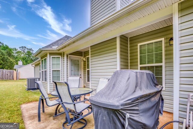 407 Gladiola Dr, Auburn, GA 30011 - deck with a patio, outdoor dining area, central AC unit, a yard, and fence