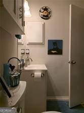 6193 Charring Cross Ct, Lithonia, GA 30058 - half bathroom with washer / dryer, baseboards, toilet, and a sink