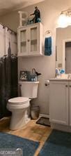 6193 Charring Cross Ct, Lithonia, GA 30058 - bathroom with toilet and a shower with shower curtain