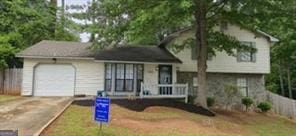 6193 Charring Cross Ct, Lithonia, GA 30058 - tri-level home with a garage and concrete driveway