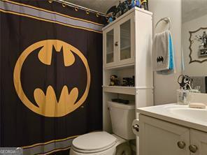 6193 Charring Cross Ct, Lithonia, GA 30058 - full bath featuring vanity, toilet, and a shower with shower curtain