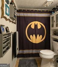 6193 Charring Cross Ct, Lithonia, GA 30058 - full bathroom featuring toilet and a shower with shower curtain