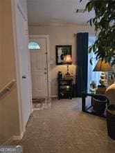 6193 Charring Cross Ct, Lithonia, GA 30058 - entryway featuring carpet floors and baseboards