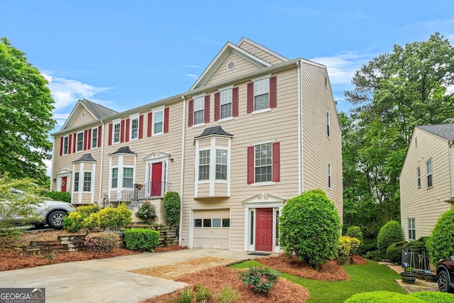 townhome / multi-family property with a garage and driveway