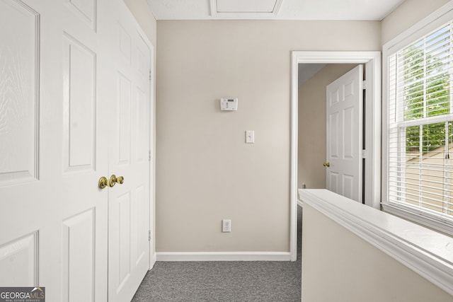 corridor featuring carpet flooring and baseboards