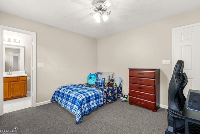 bedroom with baseboards, carpet flooring, and a sink