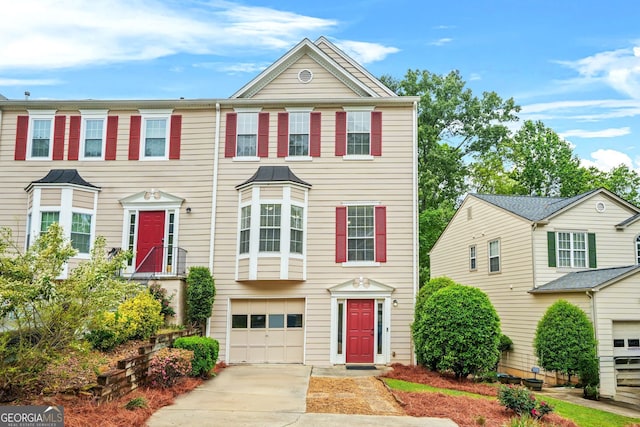 view of property featuring driveway and an attached garage