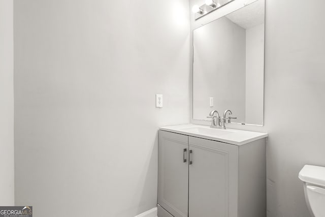 half bath with toilet and vanity