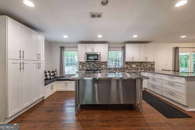4240 Cascade Rd SW, Atlanta, GA 30331 - kitchen featuring visible vents, a wealth of natural light, a peninsula, and stainless steel microwave
