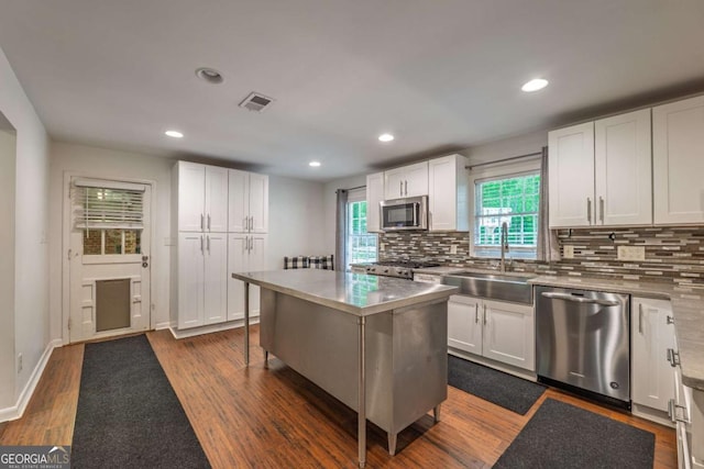 4240 Cascade Rd SW, Atlanta, GA 30331 - kitchen with a sink, stainless steel countertops, stainless steel appliances, visible vents, and white cabinetry