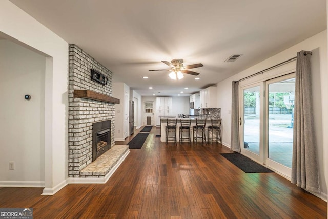 4240 Cascade Rd SW, Atlanta, GA 30331 - living room featuring ceiling fan, dark wood-style floors, baseboards, recessed lighting, and a brick fireplace