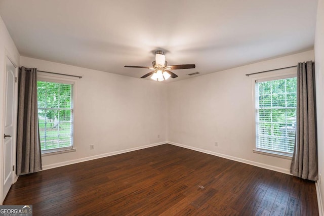 4240 Cascade Rd SW, Atlanta, GA 30331 - unfurnished room with dark wood-type flooring, a wealth of natural light, a ceiling fan, and baseboards