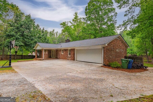 4240 Cascade Rd SW, Atlanta, GA 30331 - view of front of house featuring a porch, brick siding, fence, driveway, and an attached garage