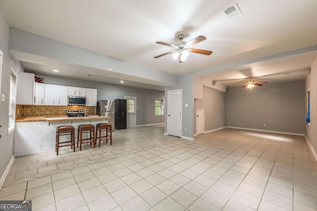 4240 Cascade Rd SW, Atlanta, GA 30331 - living room featuring ceiling fan, visible vents, and baseboards