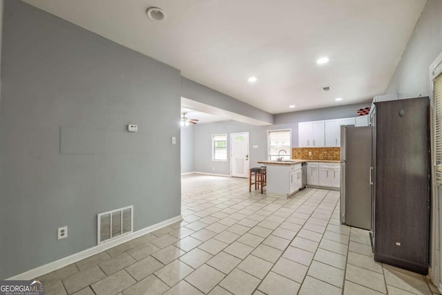 4240 Cascade Rd SW, Atlanta, GA 30331 - kitchen with a sink, stainless steel appliances, visible vents, white cabinetry, and open floor plan