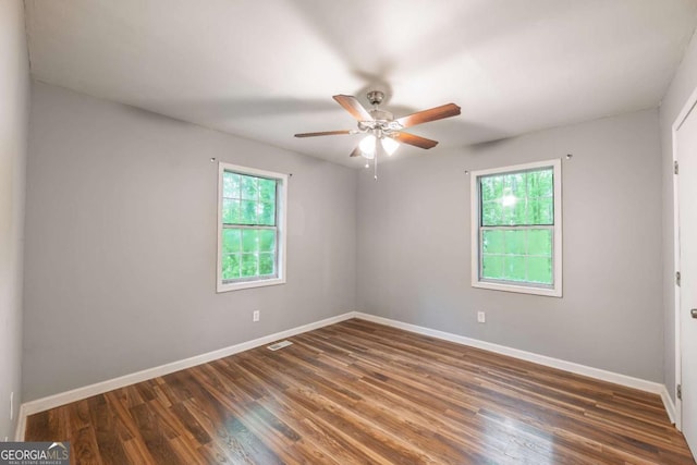 4240 Cascade Rd SW, Atlanta, GA 30331 - unfurnished room featuring baseboards, visible vents, a ceiling fan, and dark wood-type flooring